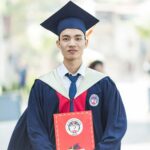 Man In Toga Holding Diploma