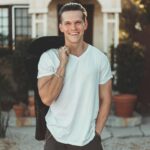 Man in White V-neck T-shirt and Black Pants